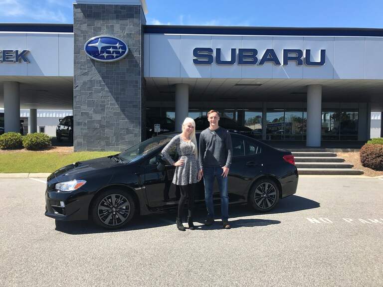 Ty with Sales Advisor Ava in front of his new 2017 Subaru WRX.JPG