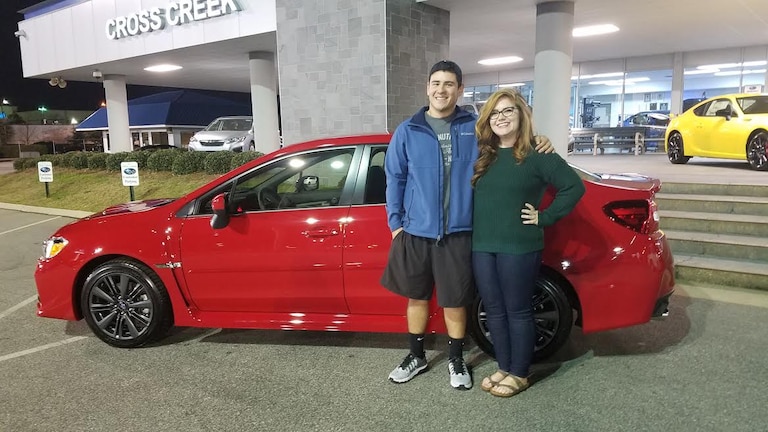 Kevin Lievano with Sr Sales Advisor Emily and his 2017 WRX.jpg