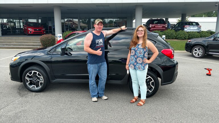 Brandon Thomson with Sales Advisor Emily in front of his new 2017 Crosstrek.jpg