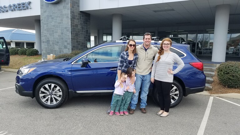 The Lyons family with their first Subaru - a 2017 Outback and Sr Sales Advisor Emily Bracey on the right.jpg