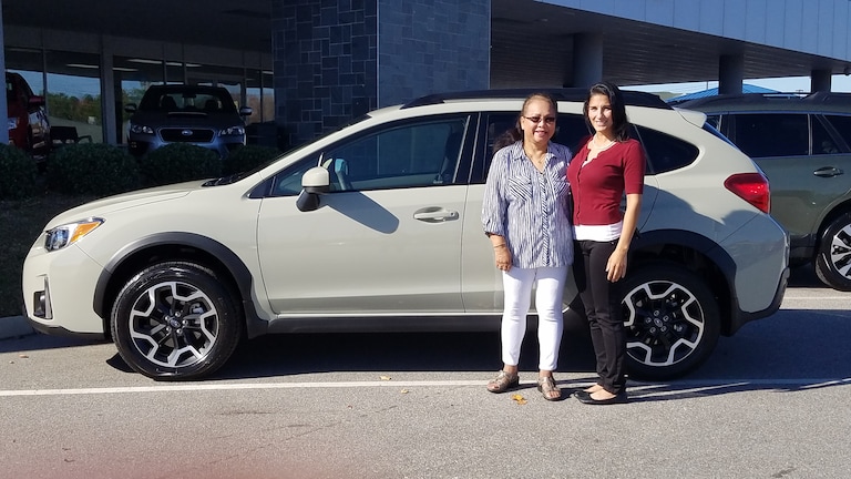 Annie with Sales Advisor Leidy in front of her new Crosstrek.jpg