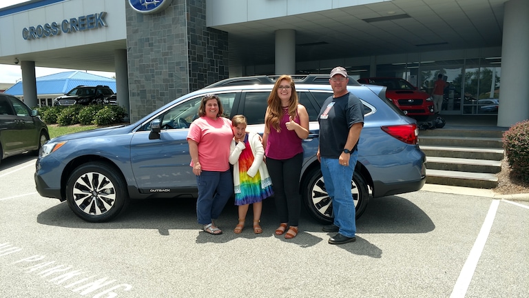 Mr & Mrs Lopez with their daughter and Sr Sales Advisor in front of their new 2017 Outback.jpg