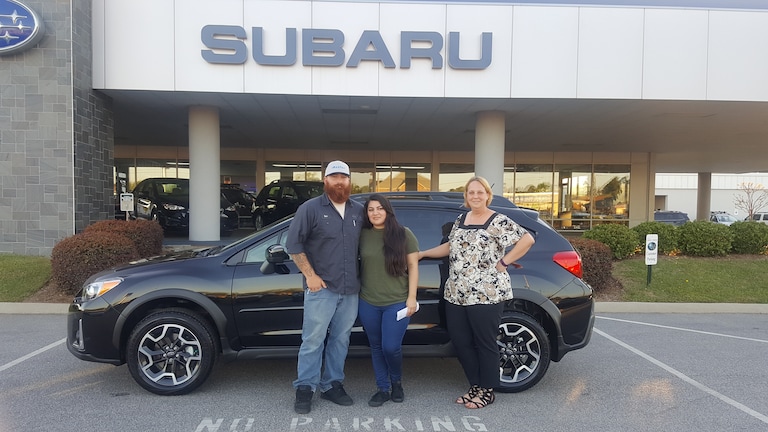 Mr & Mrs Feathers with Sales Advisor Kristen in front of their first Subaru - a 2017 Crosstrek.jpg
