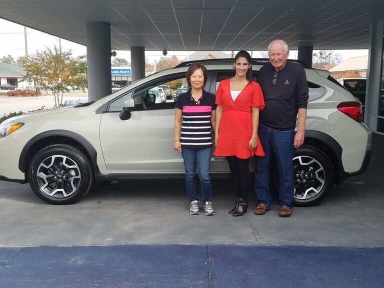 Donald and Chom Hodgen with Sales Advisor Leidy Rhines in front of their new 2016 Crosstrek.jpg