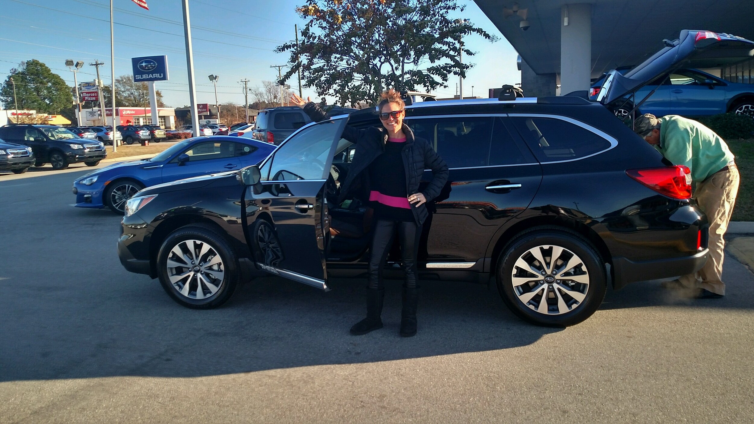 Suzanne Cabaniss with her brand new 2017 Outback as her husband packs it up for the next adventure!.jpg
