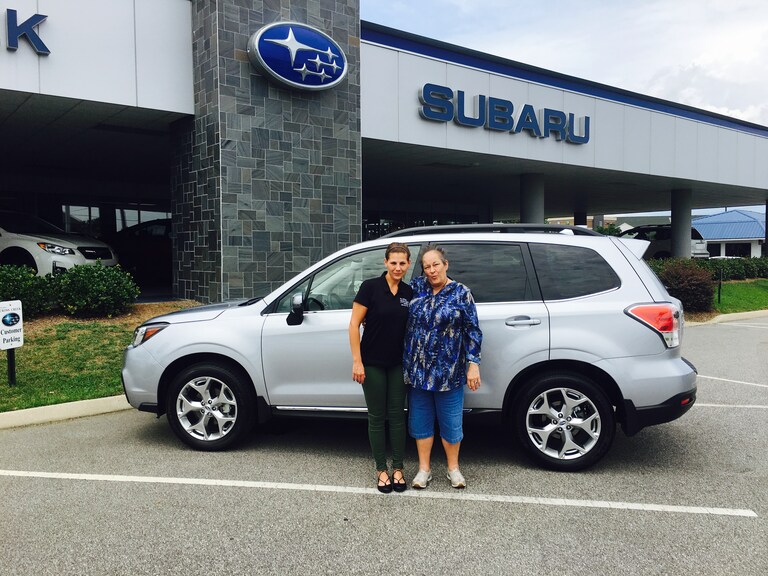 Rebecca in front of her first Subaru - a 2017 Forester. Pictured with Sales Advisor Katey Meeks.jpg