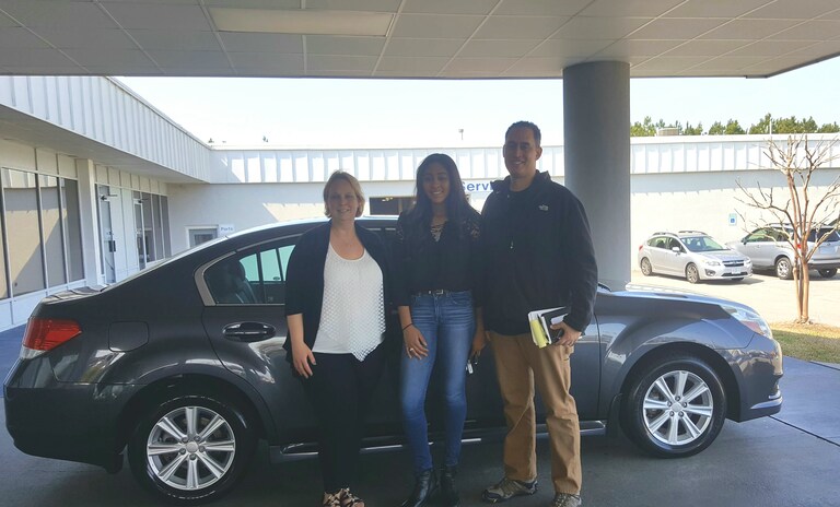 Andrew Tapscott with his daughter Jasmine and Sales Advisor Kristen in front of the 2011 Legacy they just purchased for Jasmine.jpg