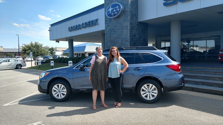 Cathy with Sr Sales Advisor Emily in front of her new 2017 Outback.jpg