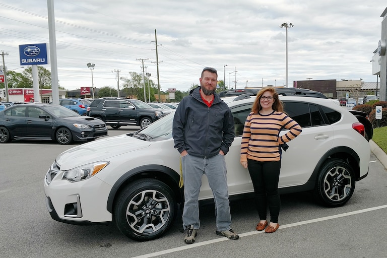 Jason Bullard with Sr Sales Advisor Emily in front of the Crosstrek he purchased for his daughter.jpg