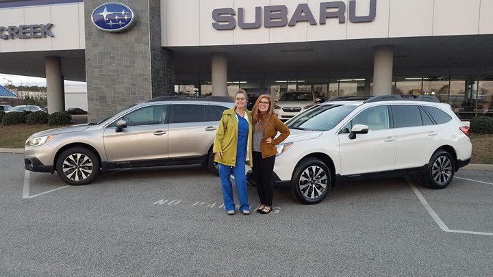 Robin Sessoms with both her old Outback and her NEW Outback! Pictured with Sr Sales Advisor Emily Bracey.jpg