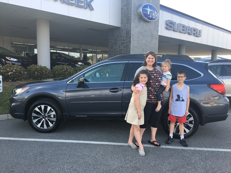 Mrs. Ferguson and kids with her new 2017 Outback.JPG