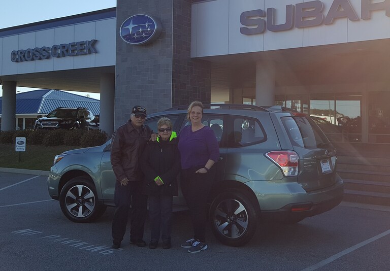 Agustin and Frances with Sales Advisor Kristen in front of their new 2017 Forester.jpg
