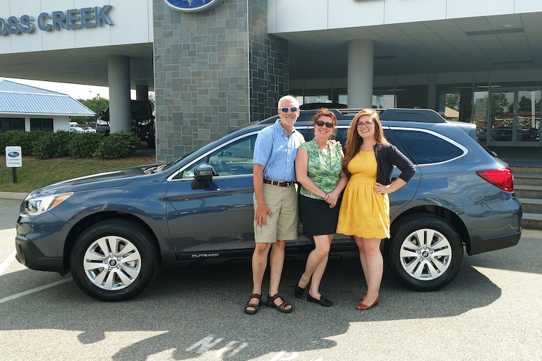 Sue & Tom with their first Subaru - a 2017 Outback. Pictured with Sr Sales Advisor Emily!.jpg