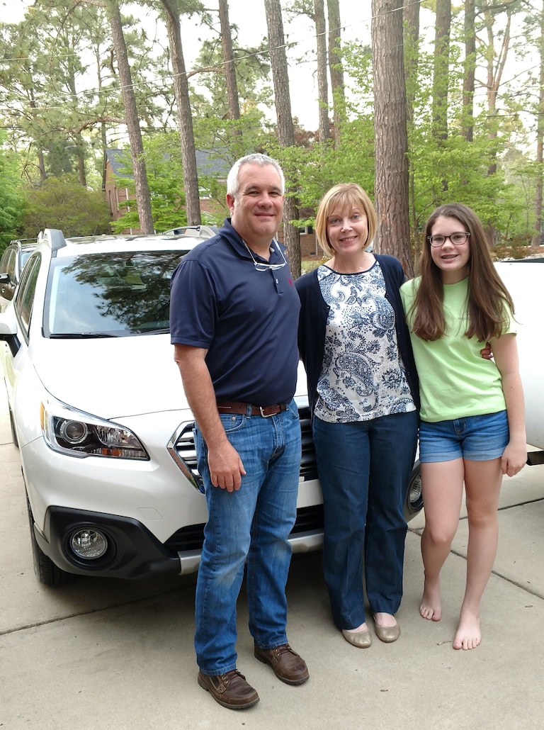 Tom, Melissa and Anna (daughter) Costello in front of their first Subaru - a 2017 Outback.jpg