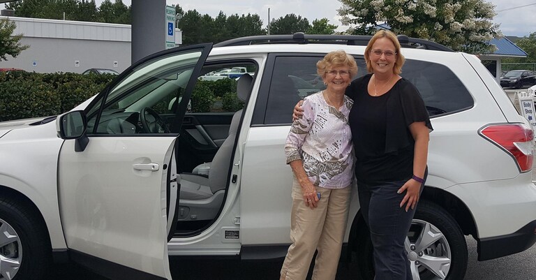 Gene with Sales Advisor Kristen in front of her new 2017 Forester.jpg