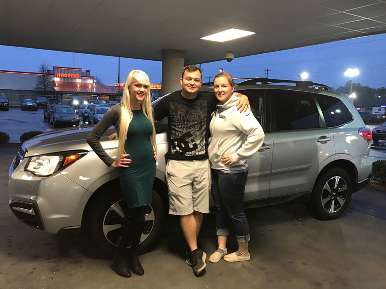 Samantha & Aaron Adams in front of their new 2014 Forester with Sales Advisor Ava.JPG