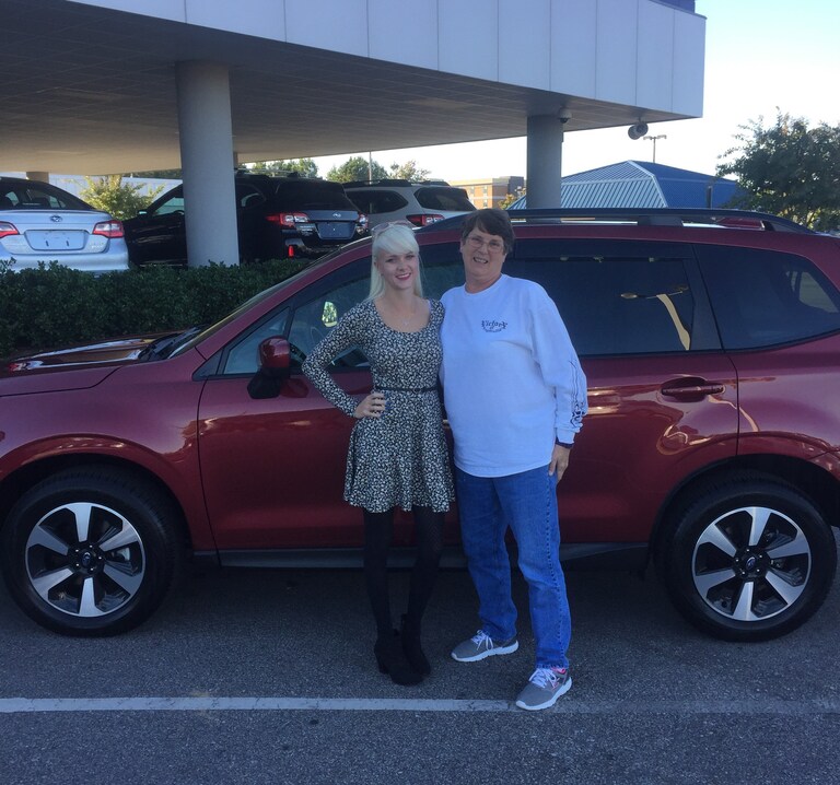 Virgina with saleswoman Ava in front of new 2017 Forester.JPG