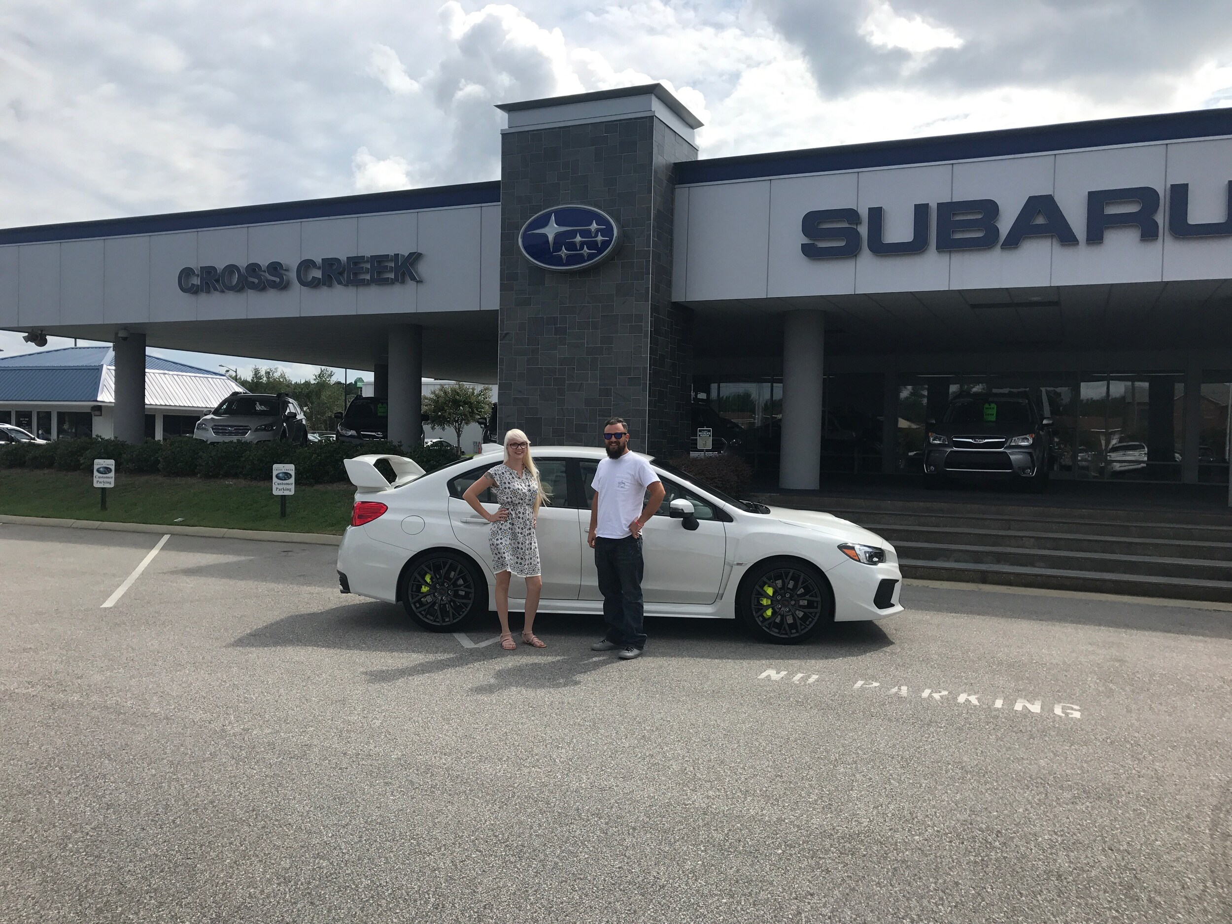 Joey in front of his 2018 WRX STI with Sales Advisor Ava.jpg