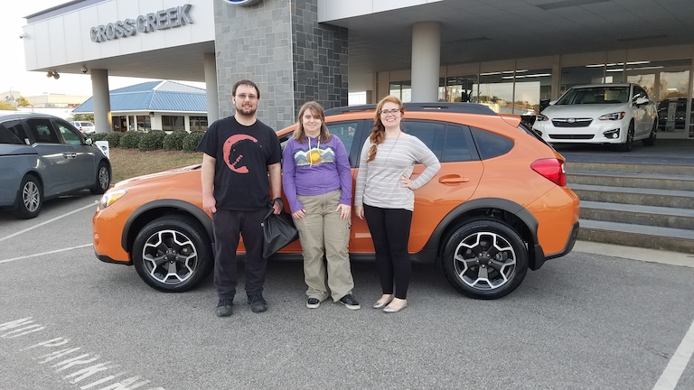 Matthew (L), his sister (C) pictured with Sr Sales Advisor Emily Bracey (R) in front of his first Subaru -a 2014 Crosstrek!.jpg