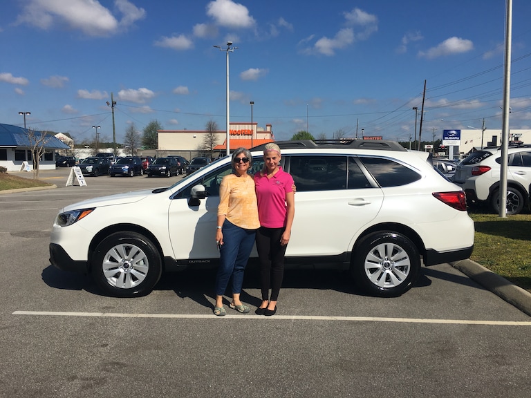 Linda with Sales Advisor Katey in front of her new 2017 Subaru Outback.JPG