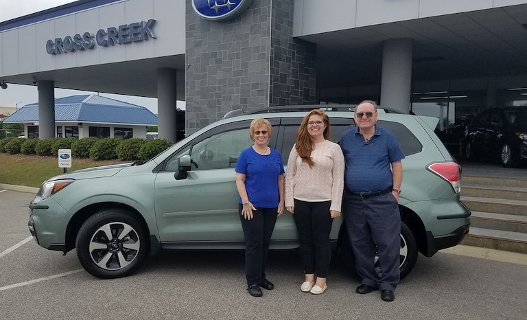 Mr & Mrs Bull with Sr Advisor Emily in front of their new 2017 Forester.jpg