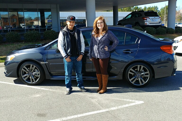 Ever Chavez with Sr Sales Advisor Emily Bracey and his new 2017 WRX.jpg