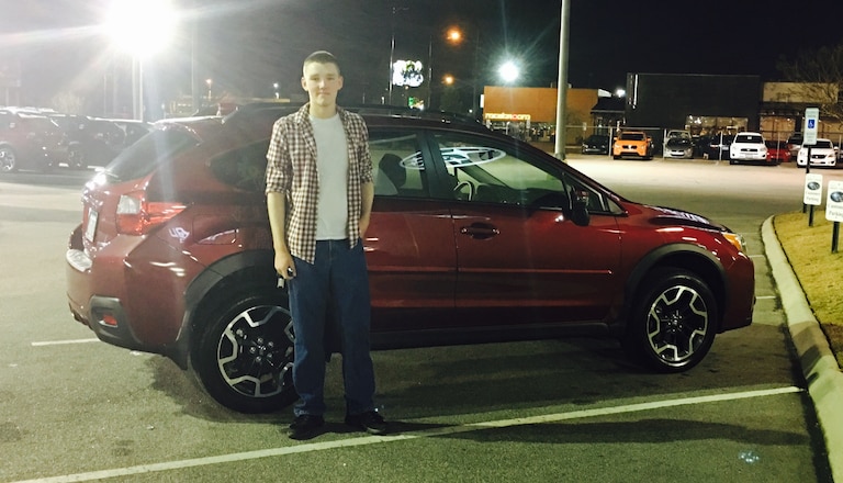 Brandon Barron with his first Subaru - a 2016 Crosstrek.JPG