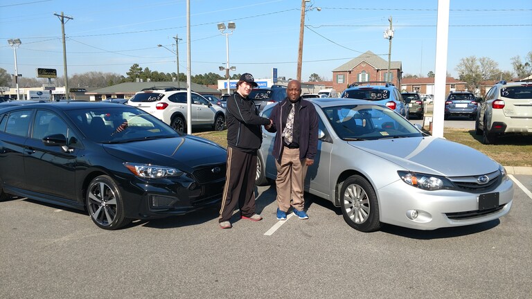 Nicholas with Sales Advisor Keith in front of his new 2017 Impreza and the Impreza he just traded in!.jpg