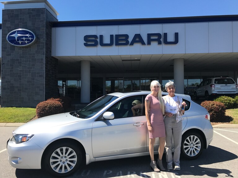Betty with Sales Advisor Ava in front of her pre-owned 2011 Impreza.JPG