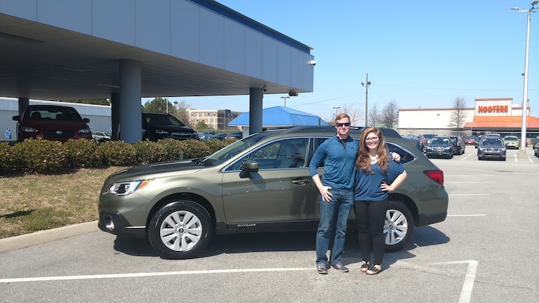 Brice Roads with Sr Sales Advisor Emily Bracey in front of his first Subaru - a 2017 Outback.jpg