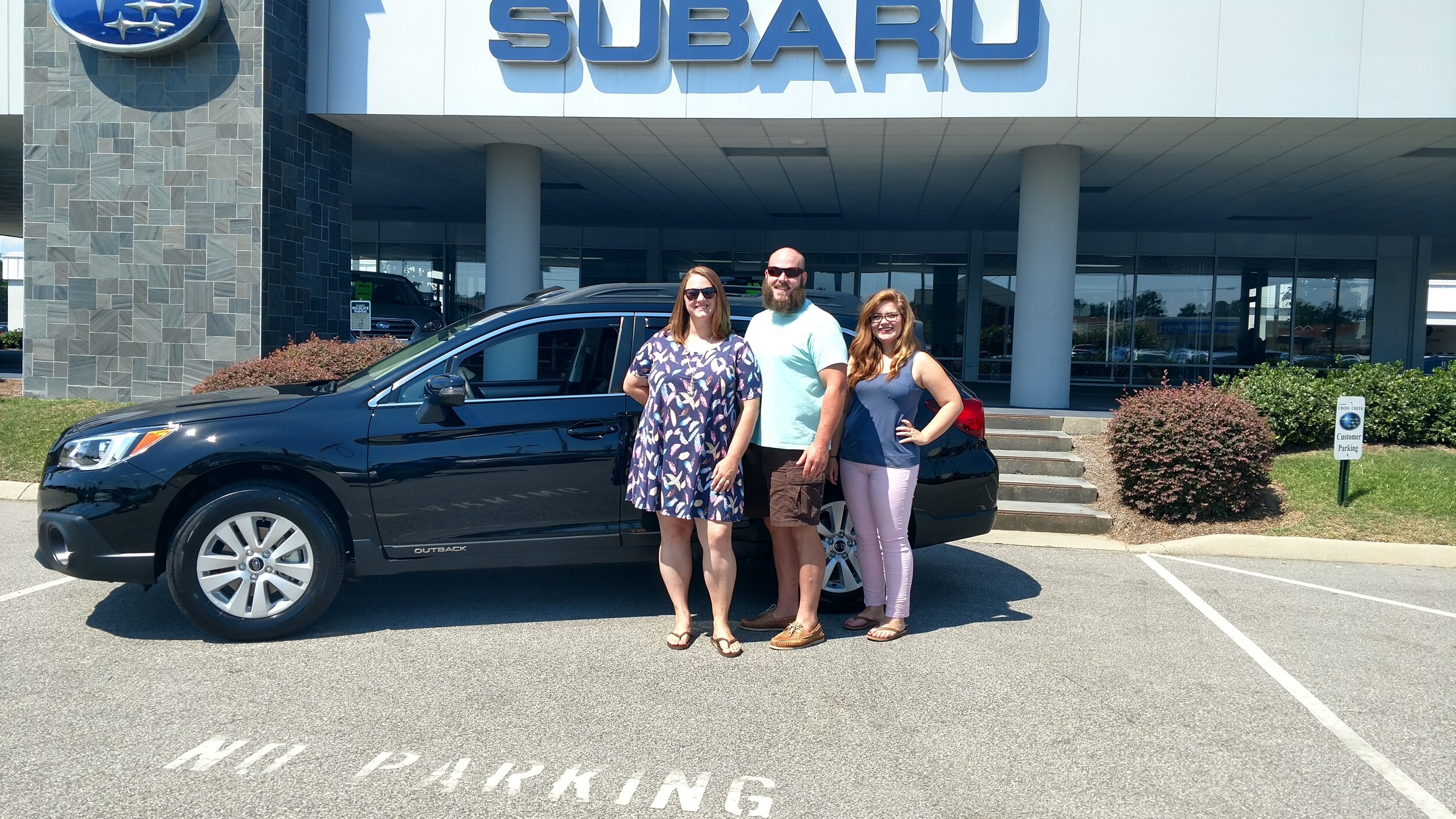 Jennifer & Sam with Sales Advisor Emily in front of their new 2017 Outback.jpg