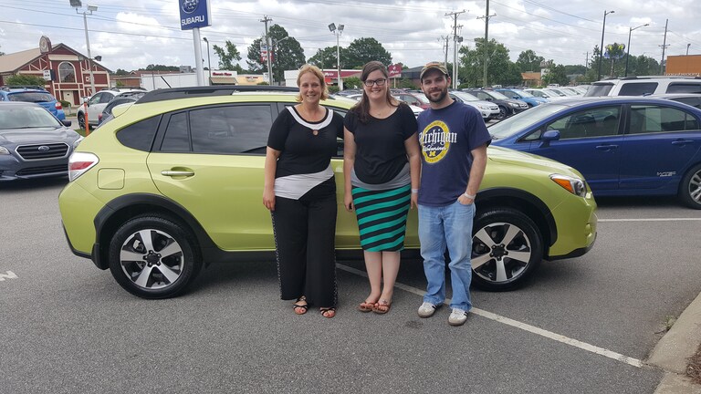 Karsie & Corey with Sales Advisor Kristen in front of their 2014 CPO Crosstrek Hybrid.jpg
