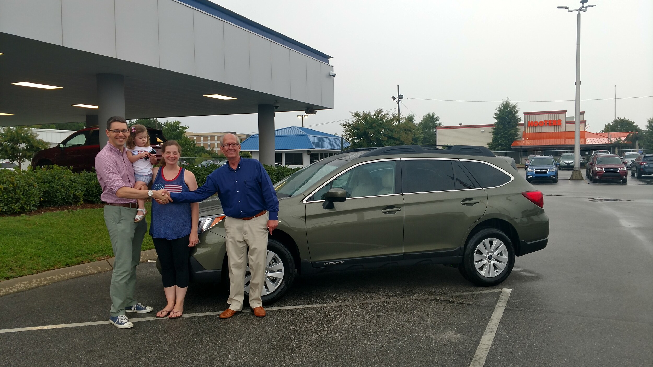 Danielle and her husband Issac with their new 2017 Outback and Sales Advisor Myc.jpg