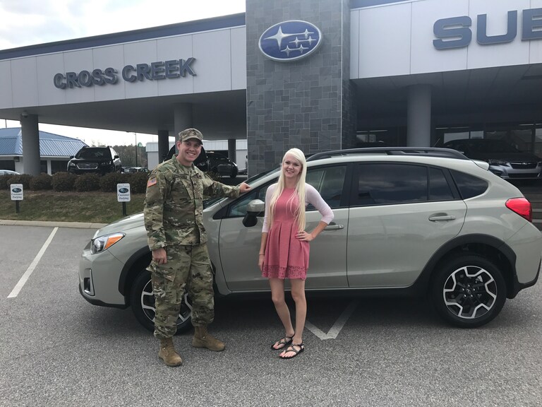 Joshua Hancock with Sales Advisor in front of his new 2017 Crosstrek.JPG