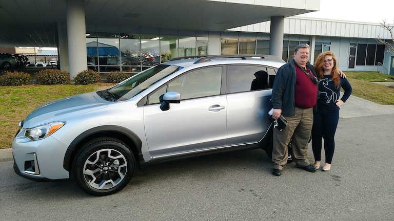 John Reagan with Sr Sales Advisor Emily Bracey in front of his new 2017 Crosstrek.jpg