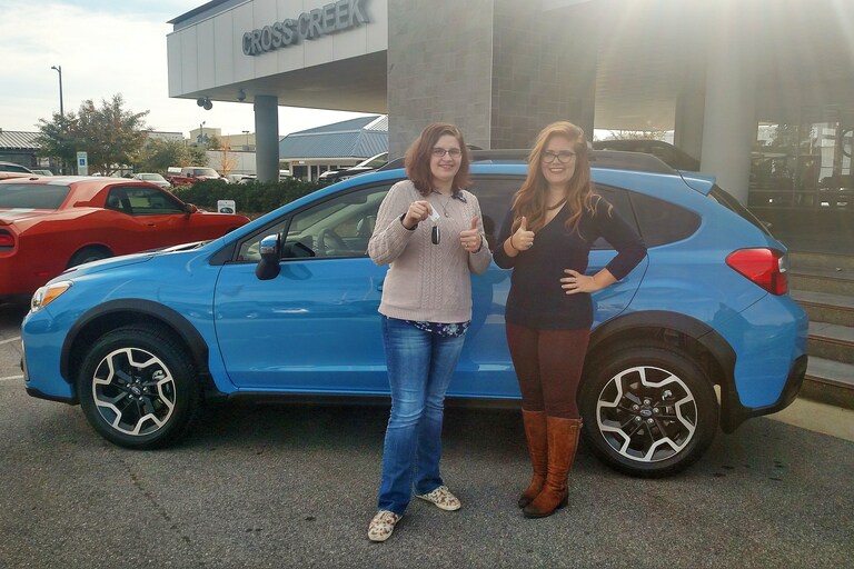 Cody Rohrbach with Senior Sales Advisor, Emily Bracey and her first Subaru - a Crosstrek!.jpg