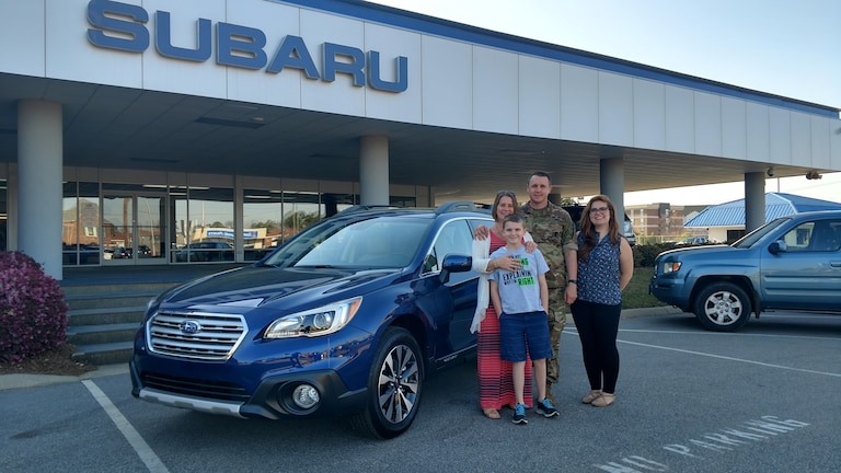 Dan Nicky & their son Dean with Sales Advisor Emily in front of their 2017 Outback.jpg