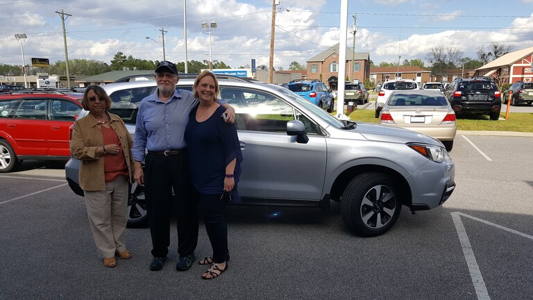 Gerald and Molla with Sales Advisor Kristen in front of the 2005 Outback they traded in for their new 2017 Forester.jpg