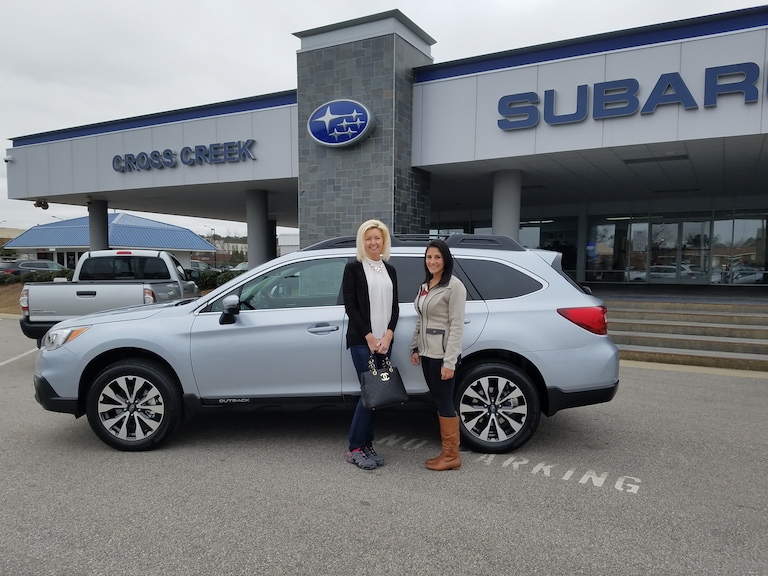 Lisa and Sales Advisor Leidy with her new 2017 Outback she decided on so she can transport pets to their new FURever homes! #Subarulovespets.jpg