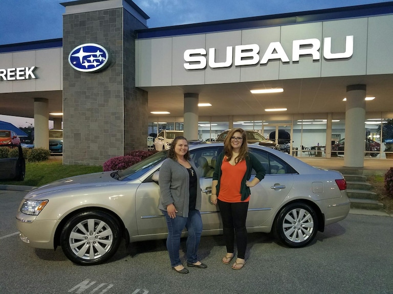 April in front of her 2009 Hyundai Sonata with Sr Sales Advisor Emily Bracey.jpeg