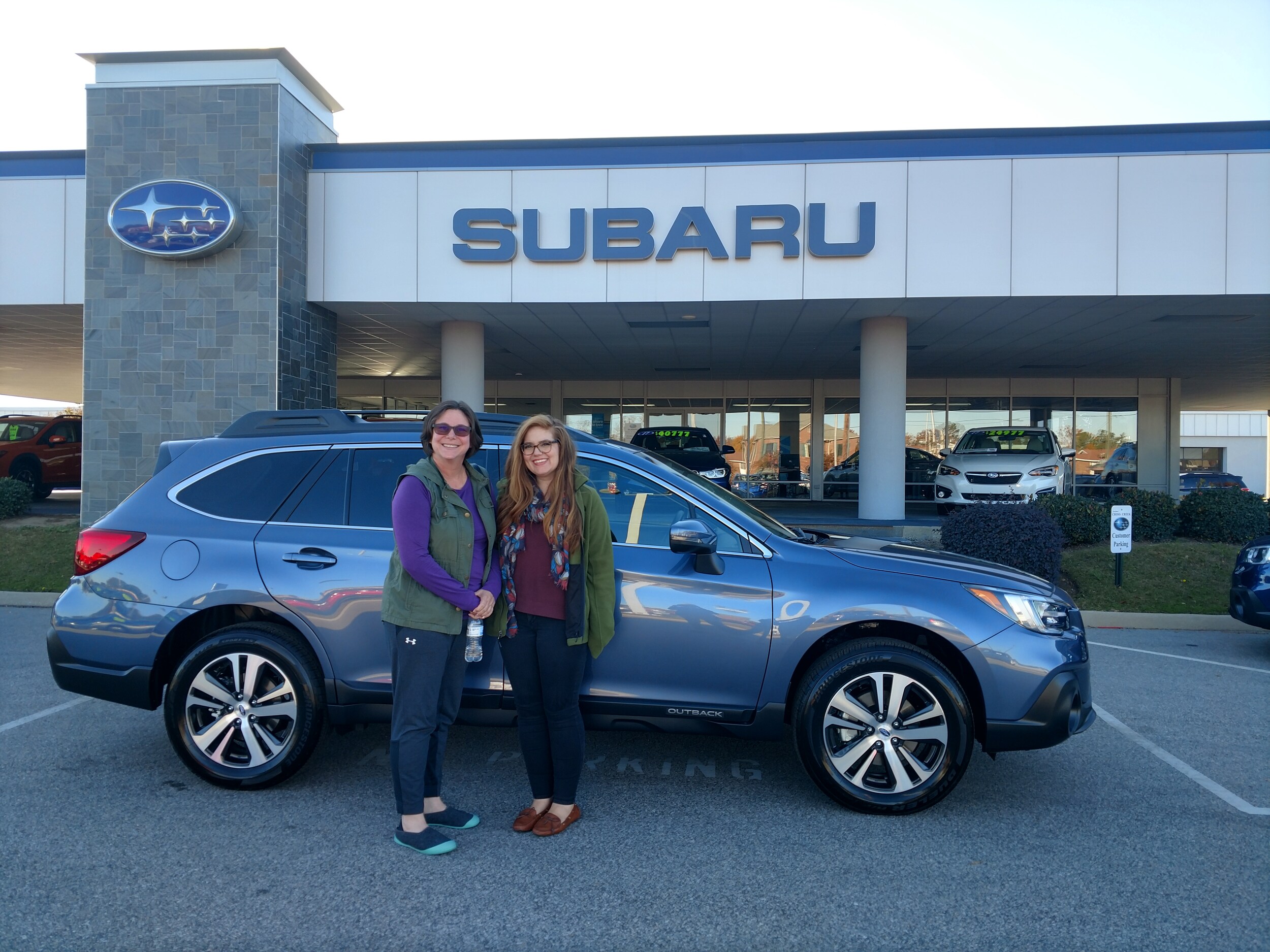 Yvonne with Sr Sales Advisor Emily in front of her 2018 Outback.jpg