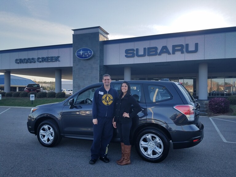 Michael with Sales Advisor Leidy in front of his 2017 Forester manual.jpg