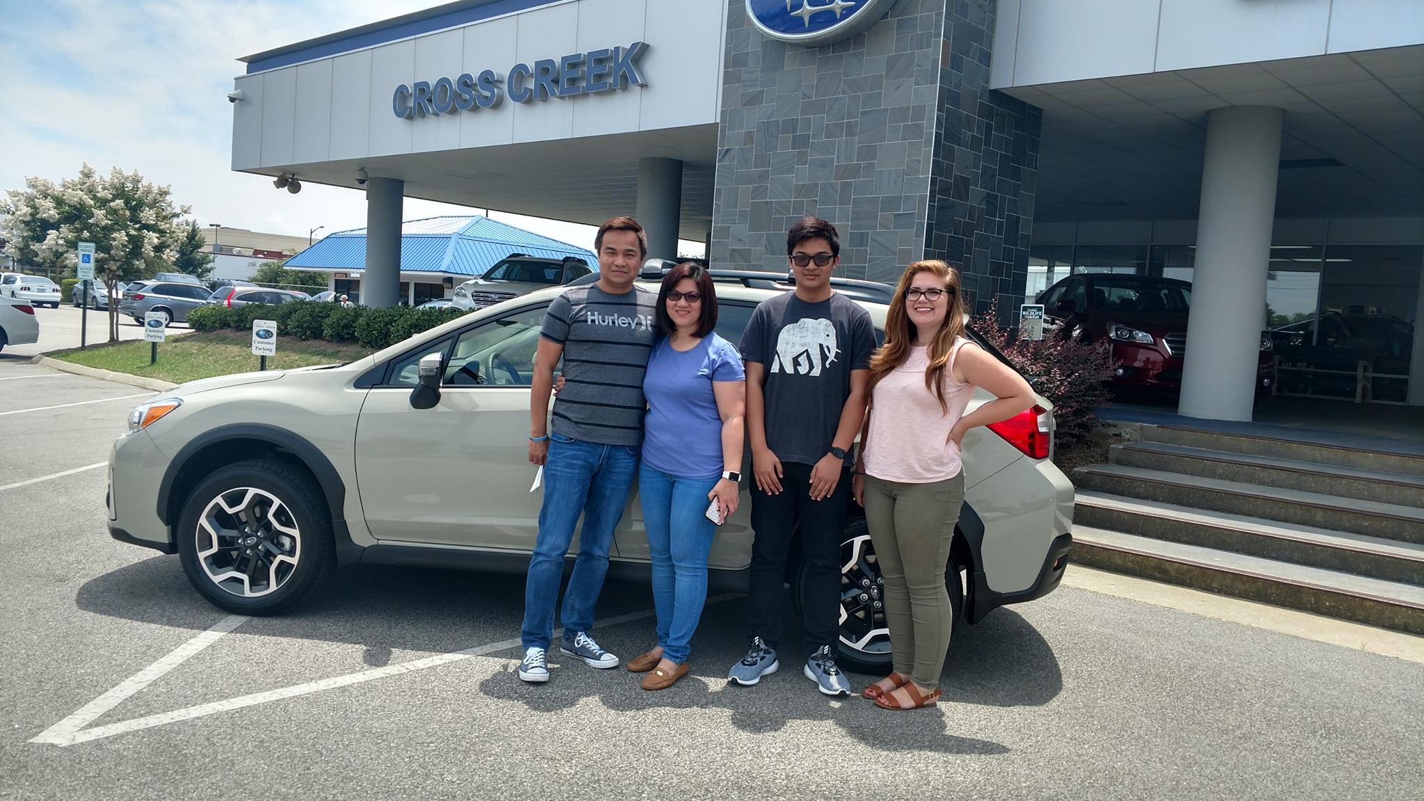 The Reyes family with Sr Sales Advisor Emily in front of their new 2017 Crosstrek.jpg