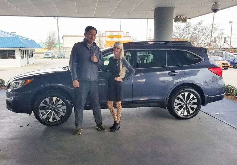 Mr. Park and his first Subaru, a brand new 2017 Outback leased for his wife (not pictured)who is expecting their first child. (pictured with Sales Advisor .jpg