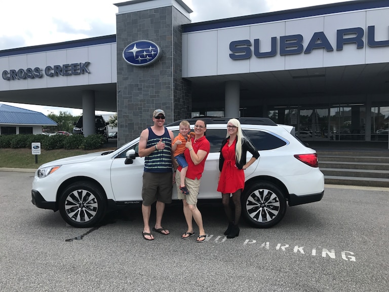 Zachary, Trisha and son Jackson with Sales Advisor Ava in front of their first Subaru - a 2017 Outback.JPG