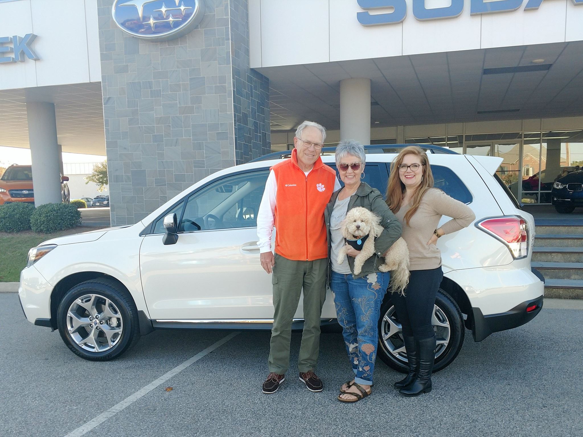 The Todds with Emily and their pup, Hummer, in front of their new 2018 Forester.jpg