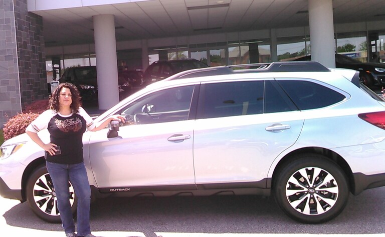 Anita in front of her new 2017 Outback.jpg