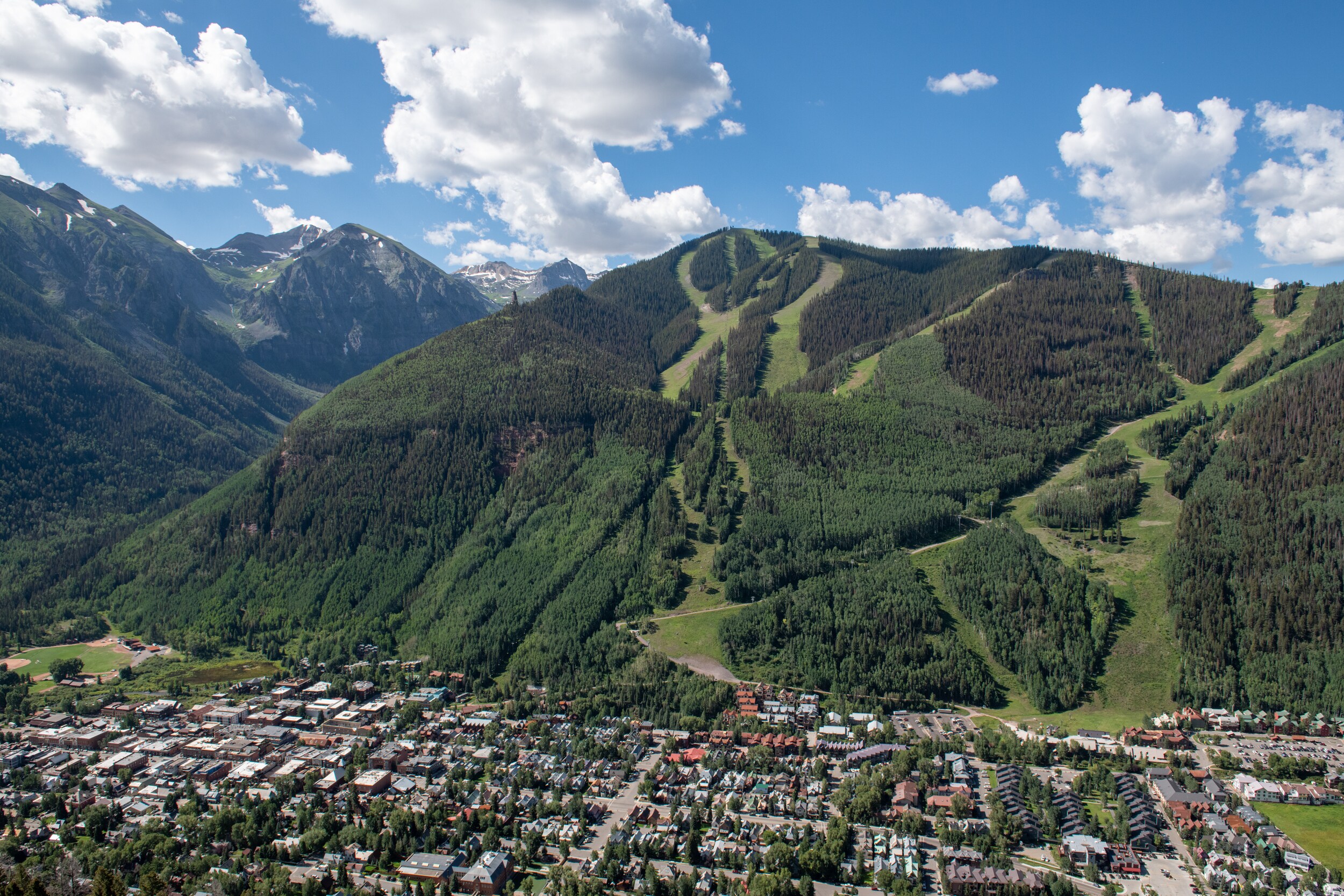 AdobeStock_413597756.jpeg An areal view of the town of Aspen with the ski slopes in the background.