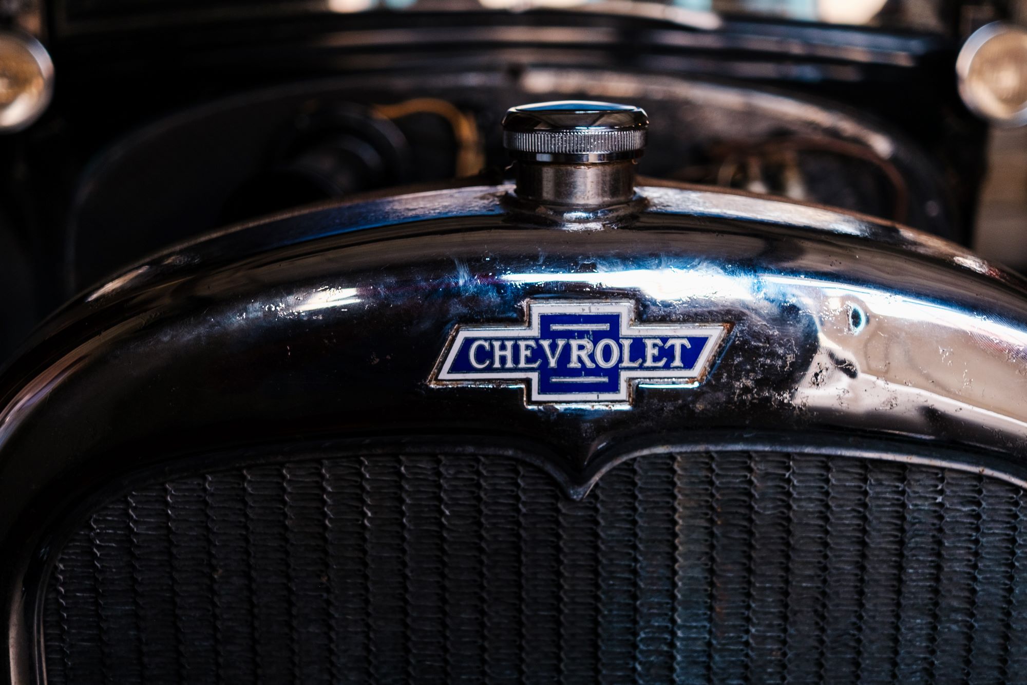 AdobeStock_639632139.jpeg The Original Chevrolet Logo on the front of a classic car.