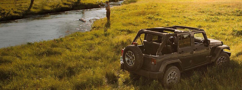 Test Drive a Jeep Trail Rated Vehicle Today A man fishing with his 2018 Jeep Wrangler